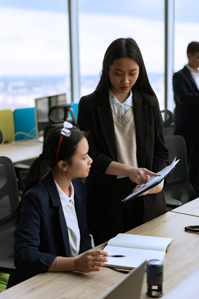 Two professionals collaborating in an office environment, focused on teamwork and productivity.